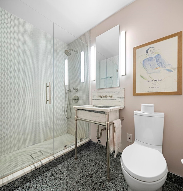 bathroom with toilet and a stall shower