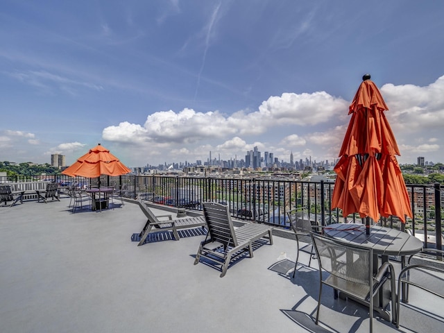 view of patio / terrace with a skyline view and outdoor dining space