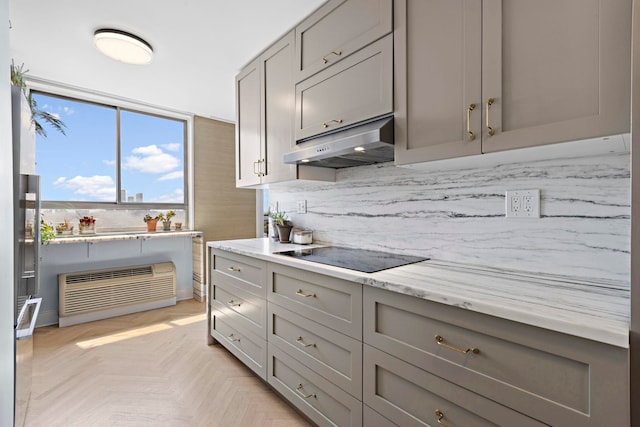 100 Manhattan Ave Unit 1517, Union City, NJ 07087 - kitchen with black electric stovetop, gray cabinetry, under cabinet range hood, and decorative backsplash