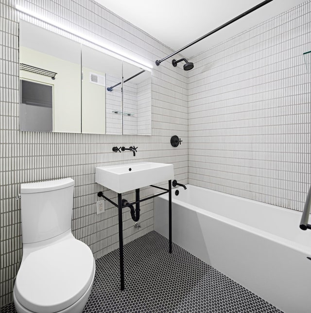 100 Manhattan Ave Unit 1517, Union City, NJ 07087 - bathroom featuring tile walls, washtub / shower combination, and tile patterned flooring