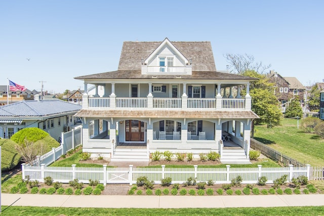 26 Bridge St, Bay Head Borough, NJ 08742 - view of front of property with a balcony, a porch, a fenced front yard, and a gate