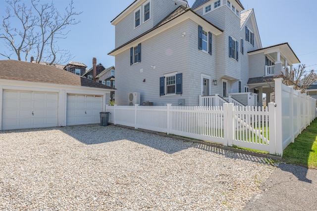 26 Bridge St, Bay Head Borough, NJ 08742 - view of home's exterior with an outdoor structure, a garage, a fenced front yard, and driveway