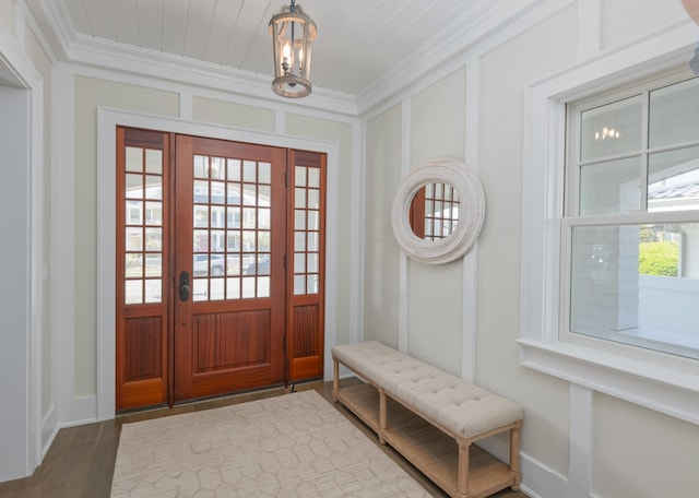 26 Bridge St, Bay Head Borough, NJ 08742 - foyer entrance with ornamental molding, a chandelier, wood finished floors, baseboards, and a decorative wall