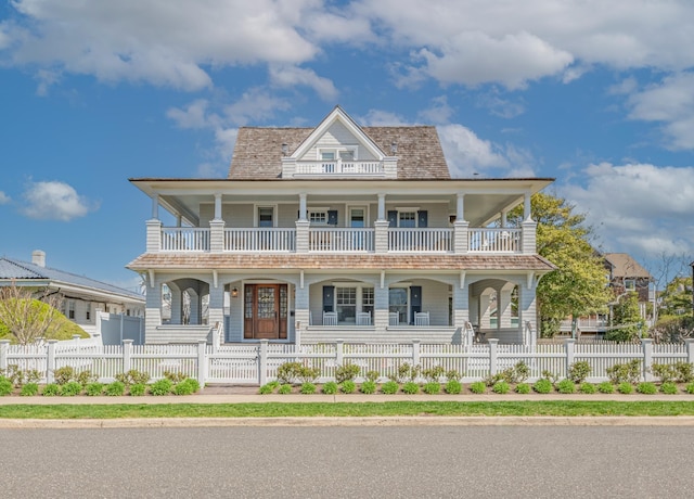 26 Bridge St, Bay Head Borough, NJ 08742 - view of front of property with a porch, a balcony, and a fenced front yard