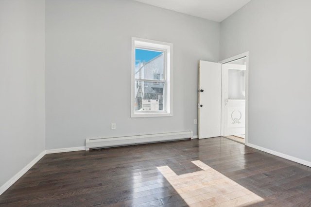 empty room with a baseboard radiator, baseboards, and hardwood / wood-style floors