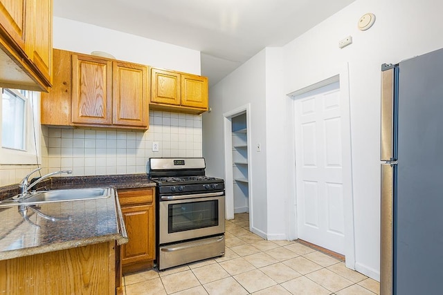 268 Bergen Ave, Jersey City, NJ 07305 - kitchen with stainless steel appliances, a sink, light tile patterned floors, and tasteful backsplash