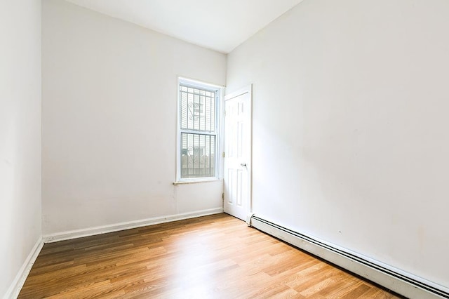 268 Bergen Ave, Jersey City, NJ 07305 - empty room featuring a baseboard heating unit, wood finished floors, and baseboards