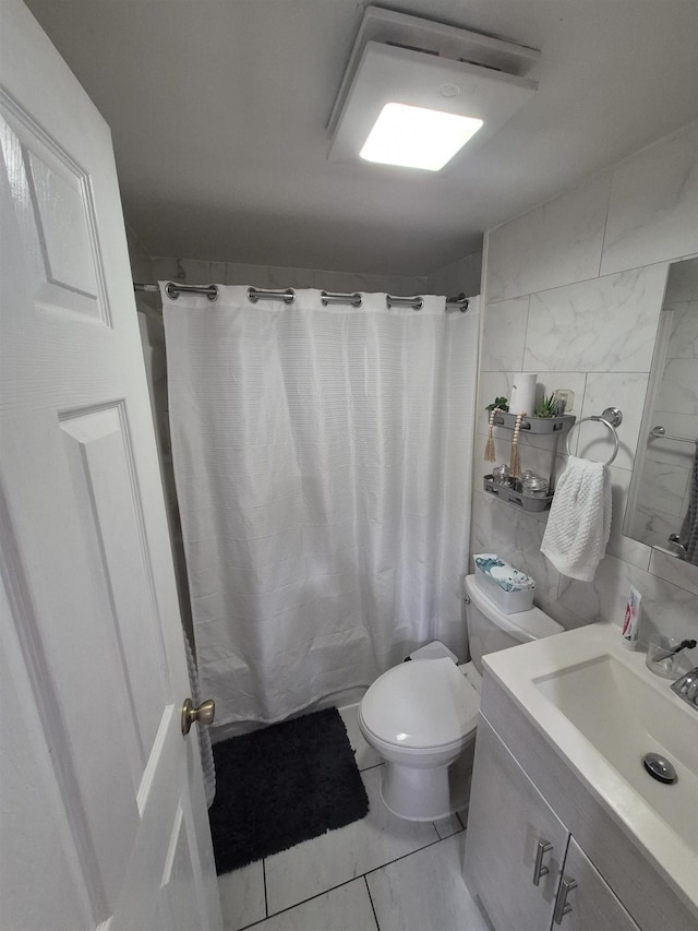 1200 Central Ave Unit B2, Union City, NJ 07087 - full bathroom with vanity, tile walls, and marble look tile flooring