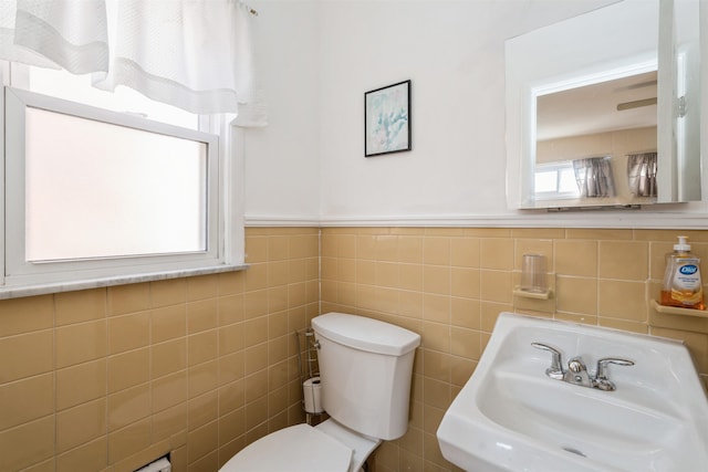 104 W 52nd St, Bayonne, NJ 07002 - bathroom featuring tile walls, toilet, wainscoting, and a sink