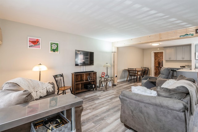 104 W 52nd St, Bayonne, NJ 07002 - living room featuring baseboards and light wood-style floors