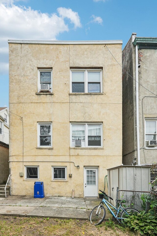6607 Kennedy Blvd, North Bergen, NJ 07047 - back of property with stucco siding and cooling unit
