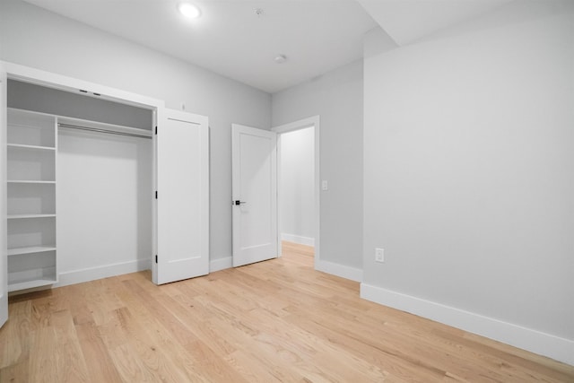 unfurnished bedroom featuring a closet and light hardwood / wood-style flooring