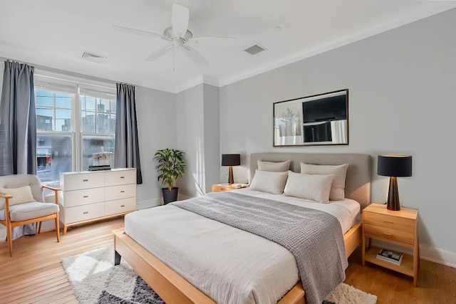 bedroom with ornamental molding, light hardwood / wood-style flooring, and ceiling fan