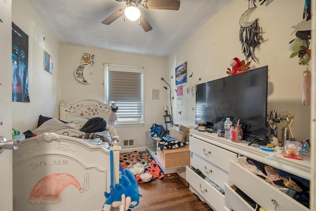 bedroom featuring dark wood-style floors, baseboards, visible vents, and a ceiling fan