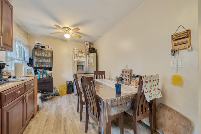 dining space featuring a ceiling fan and light wood-style floors