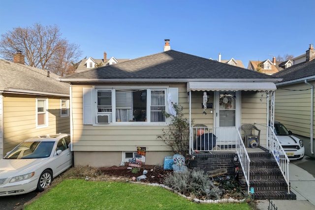 bungalow-style house with roof with shingles