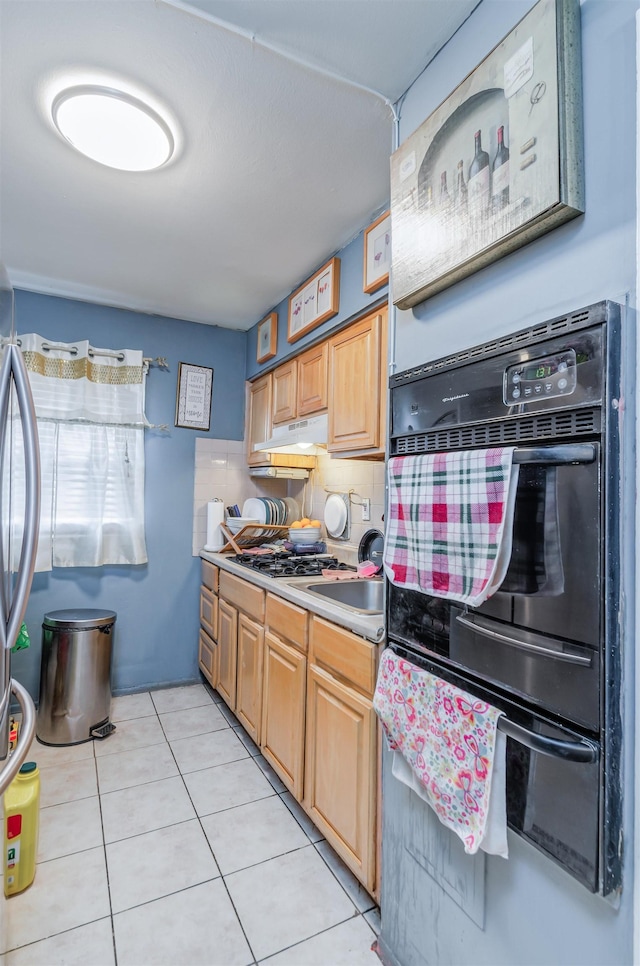 kitchen featuring wall oven, light tile patterned floors, sink, and tasteful backsplash