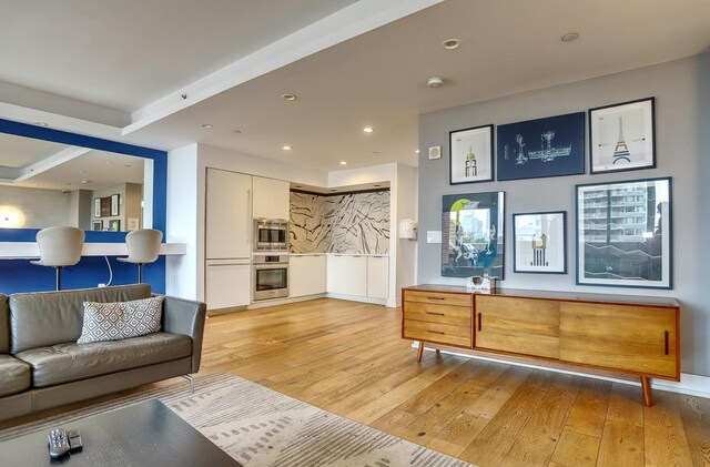 389 Washington St Unit 30C, Jersey City, NJ 07302 - living area featuring light wood-type flooring and recessed lighting