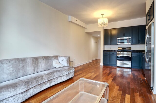 389 Washington St Unit 30C, Jersey City, NJ 07302 - living room featuring a chandelier and dark wood-style flooring