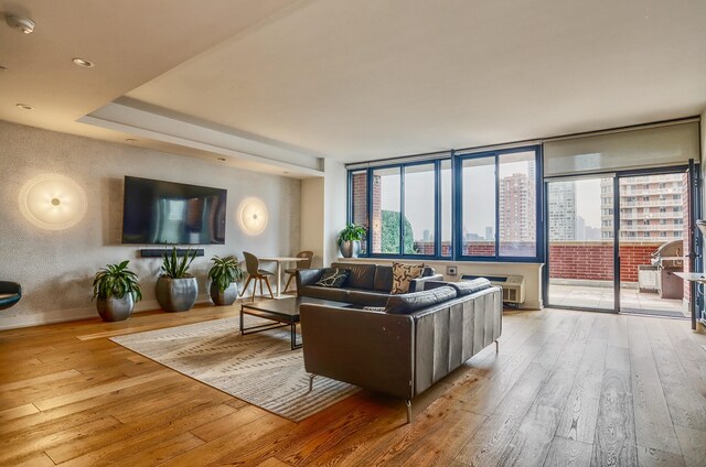 389 Washington St Unit 30C, Jersey City, NJ 07302 - living area with hardwood / wood-style floors and a wall mounted air conditioner