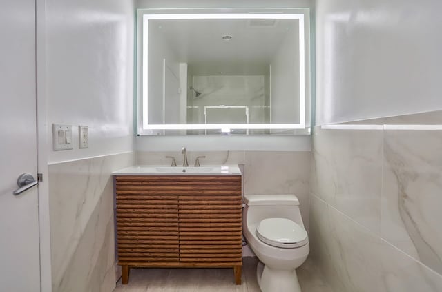 389 Washington St Unit 30C, Jersey City, NJ 07302 - bathroom featuring vanity and tile walls