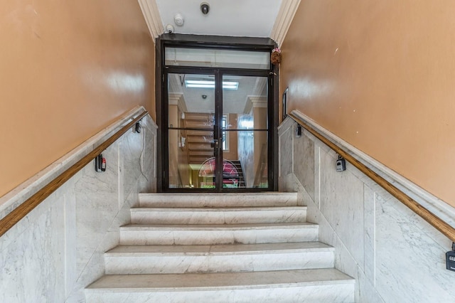 31 75th St Unit 9, North Bergen, NJ 07047 - staircase with ornamental molding and a wainscoted wall