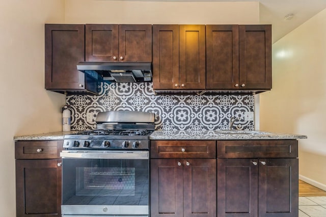 31 75th St Unit 9, North Bergen, NJ 07047 - kitchen with stainless steel gas range oven, under cabinet range hood, dark brown cabinets, and backsplash