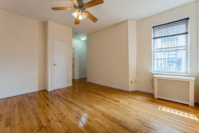 31 75th St Unit 9, North Bergen, NJ 07047 - unfurnished room featuring radiator heating unit, light wood-style floors, and ceiling fan