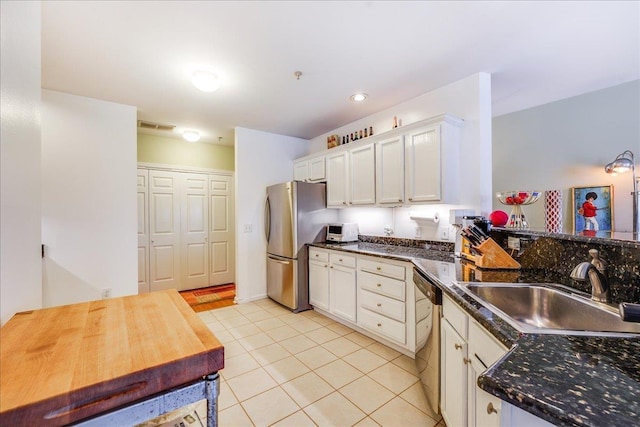 252 The Promenade Unit 252, Edgewater, NJ 07020 - kitchen with appliances with stainless steel finishes, white cabinets, and light tile patterned flooring