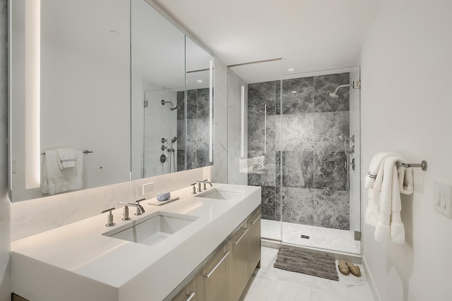 full bathroom with marble finish floor, double vanity, a sink, and a marble finish shower