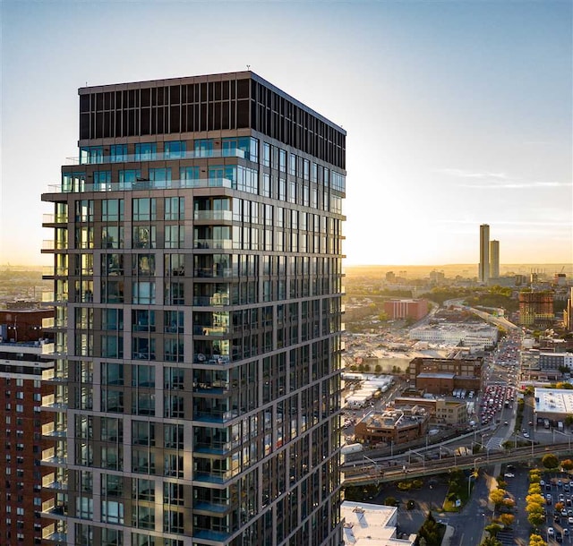 property at dusk featuring a city view