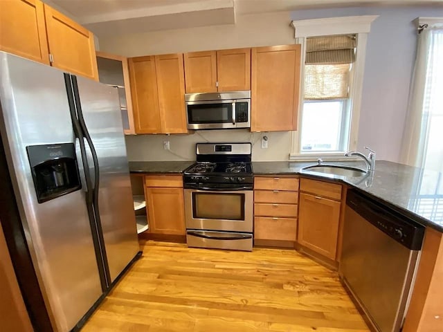 152 Highland Ave Unit 2B, Jersey City, NJ 07306 - kitchen with appliances with stainless steel finishes, light wood-type flooring, healthy amount of natural light, and dark stone counters
