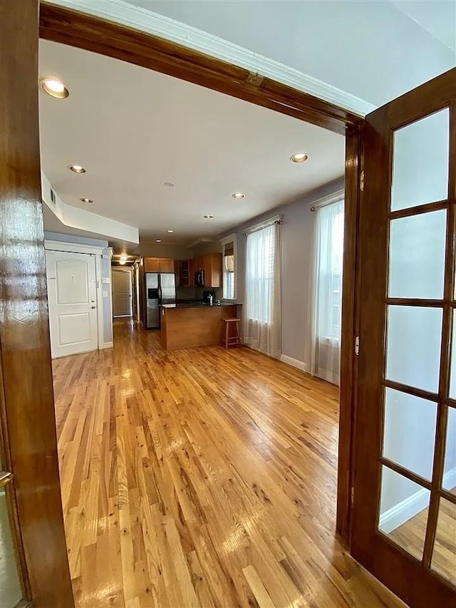 152 Highland Ave Unit 2B, Jersey City, NJ 07306 - unfurnished living room with light wood-style flooring, recessed lighting, and ornamental molding