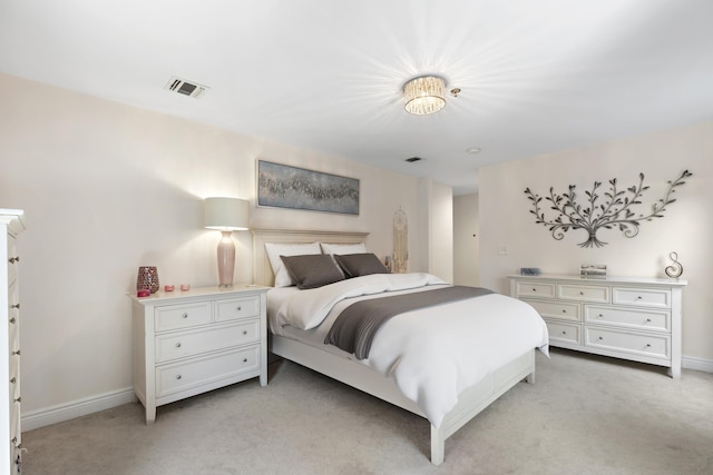 bedroom with light carpet, visible vents, and baseboards