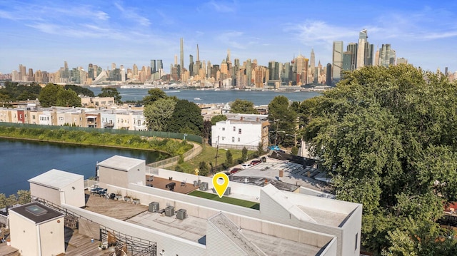 drone / aerial view featuring a city view and a water view