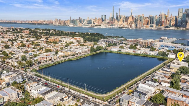 birds eye view of property featuring a water view and a city view