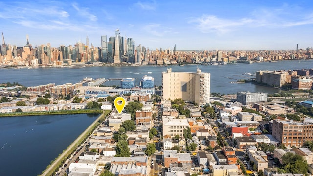 birds eye view of property with a city view and a water view