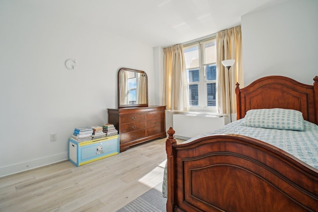 bedroom featuring light wood-style flooring and baseboards