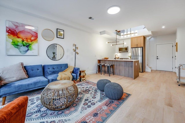 living room with light hardwood / wood-style floors