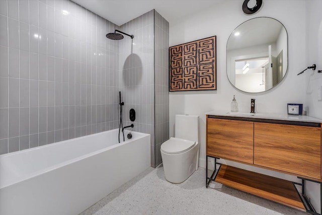 full bathroom featuring vanity, toilet, and tiled shower / bath