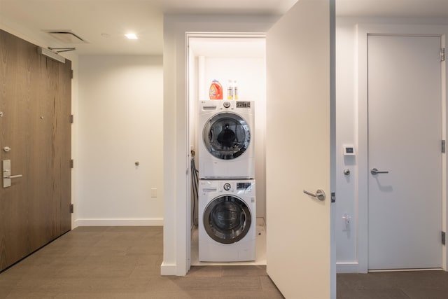 washroom featuring stacked washer and clothes dryer