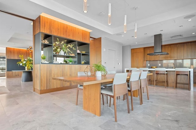 dining space with a tray ceiling