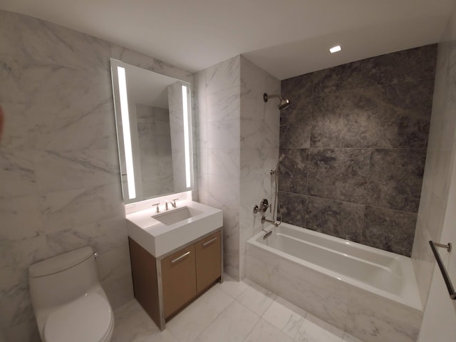 full bathroom with marble finish floor, tile walls, toilet, vanity, and a combined bath / shower with marble appearance