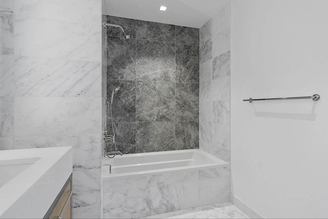 bathroom with vanity and tiled shower / bath