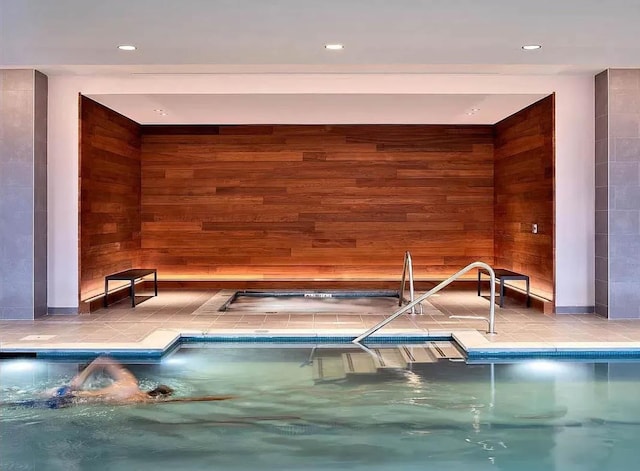 view of swimming pool featuring an indoor hot tub