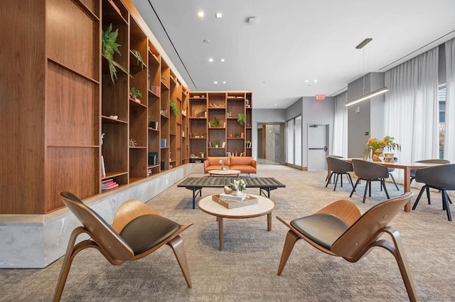 living room with light colored carpet and wooden walls