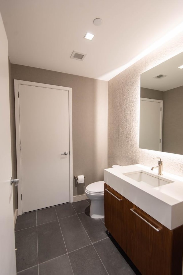 bathroom with tile patterned floors, vanity, and toilet