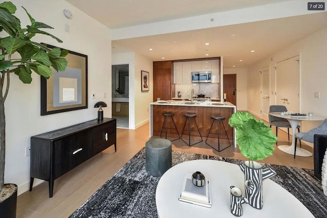 living room featuring light hardwood / wood-style flooring and sink