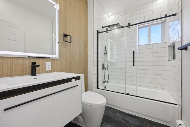 bathroom featuring enclosed tub / shower combo, toilet, a baseboard radiator, and vanity