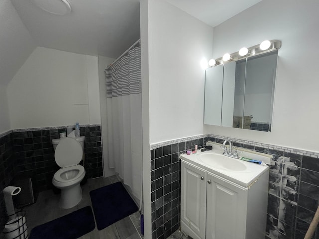 bathroom with vanity, tile walls, curtained shower, and toilet